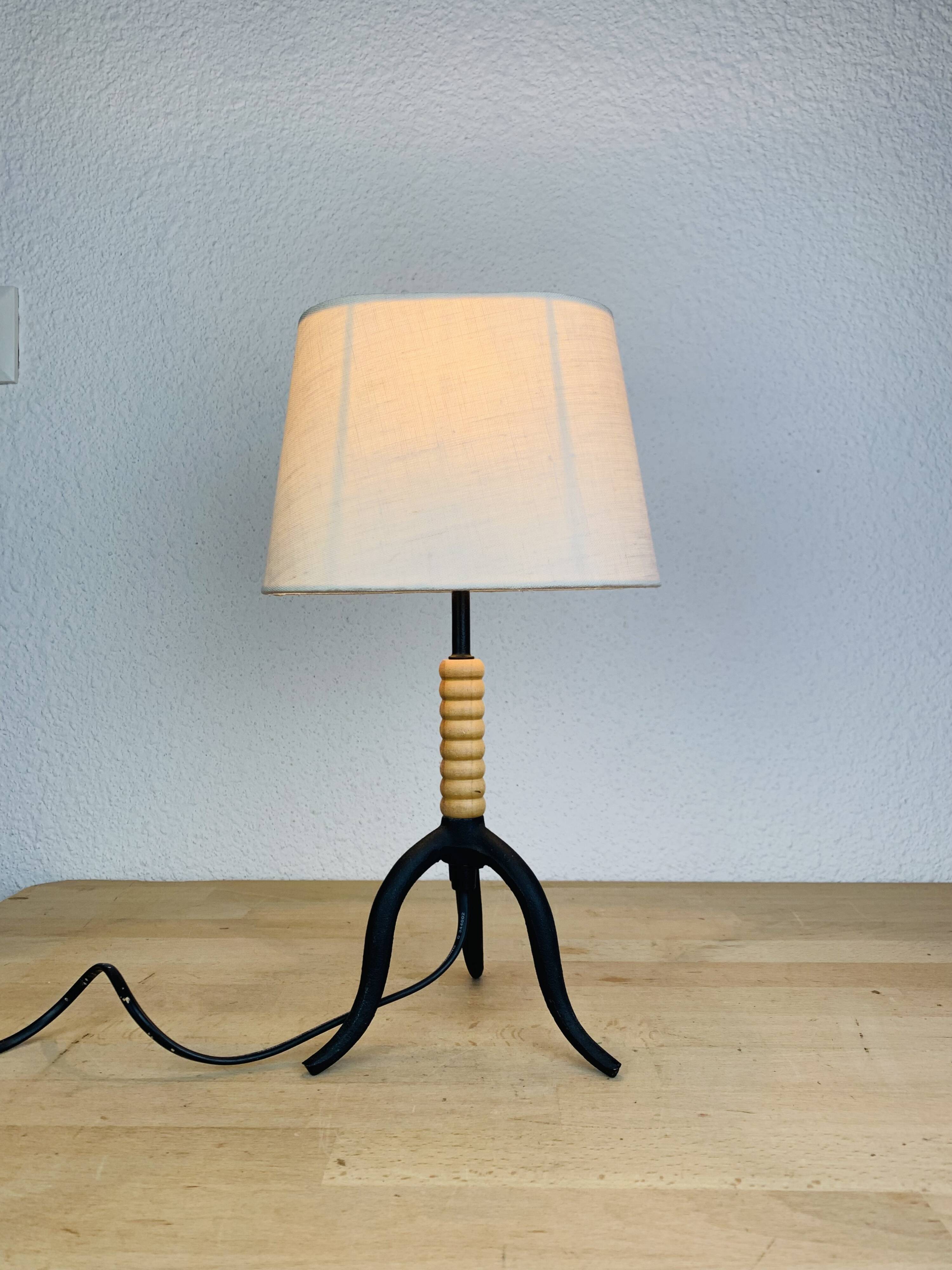 Wrought iron and wood tripod lamp