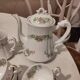 Coffee and tea cup service with plates and saucers.