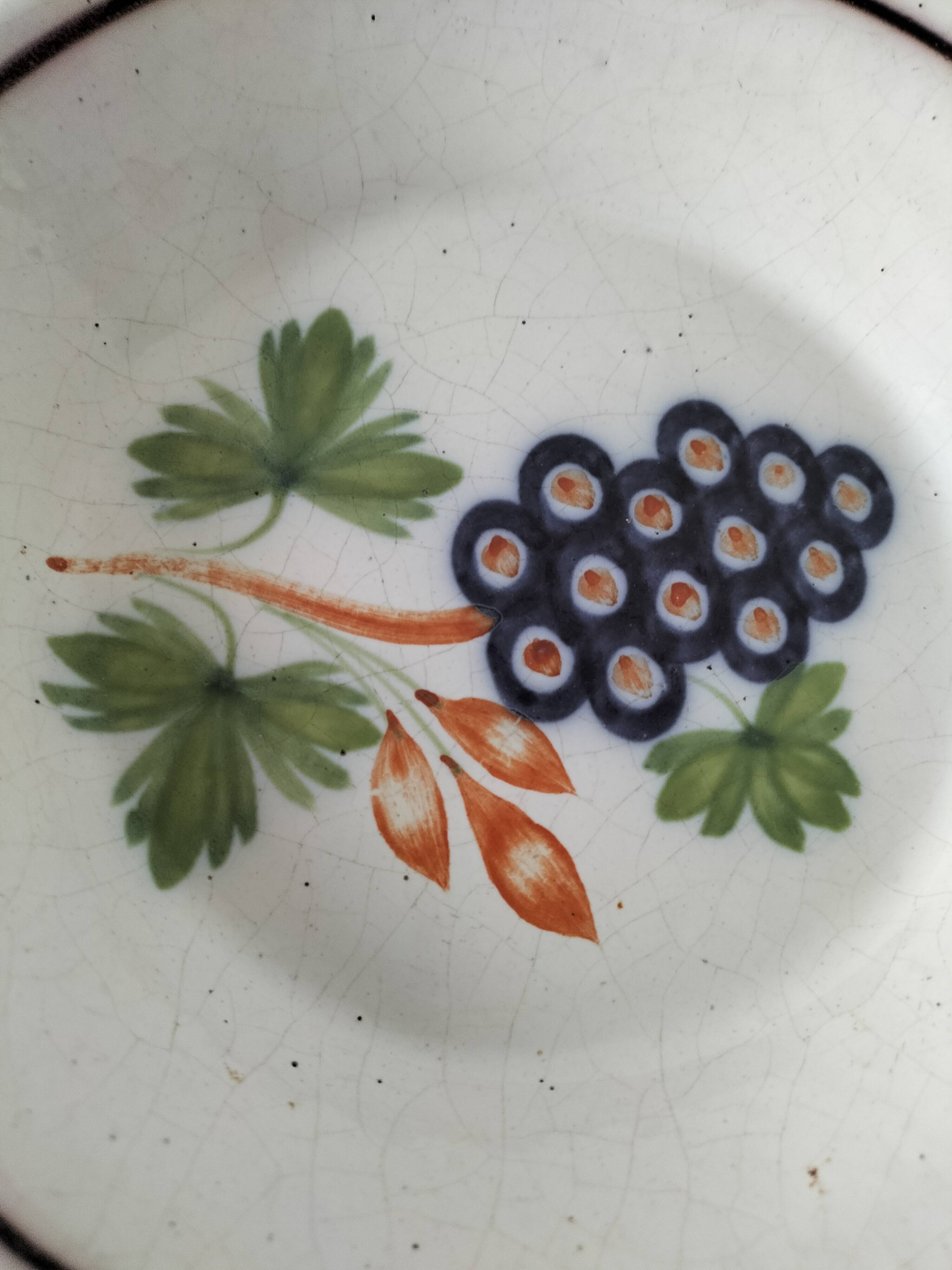 Pair of antique soup plates with hand-painted grape decoration