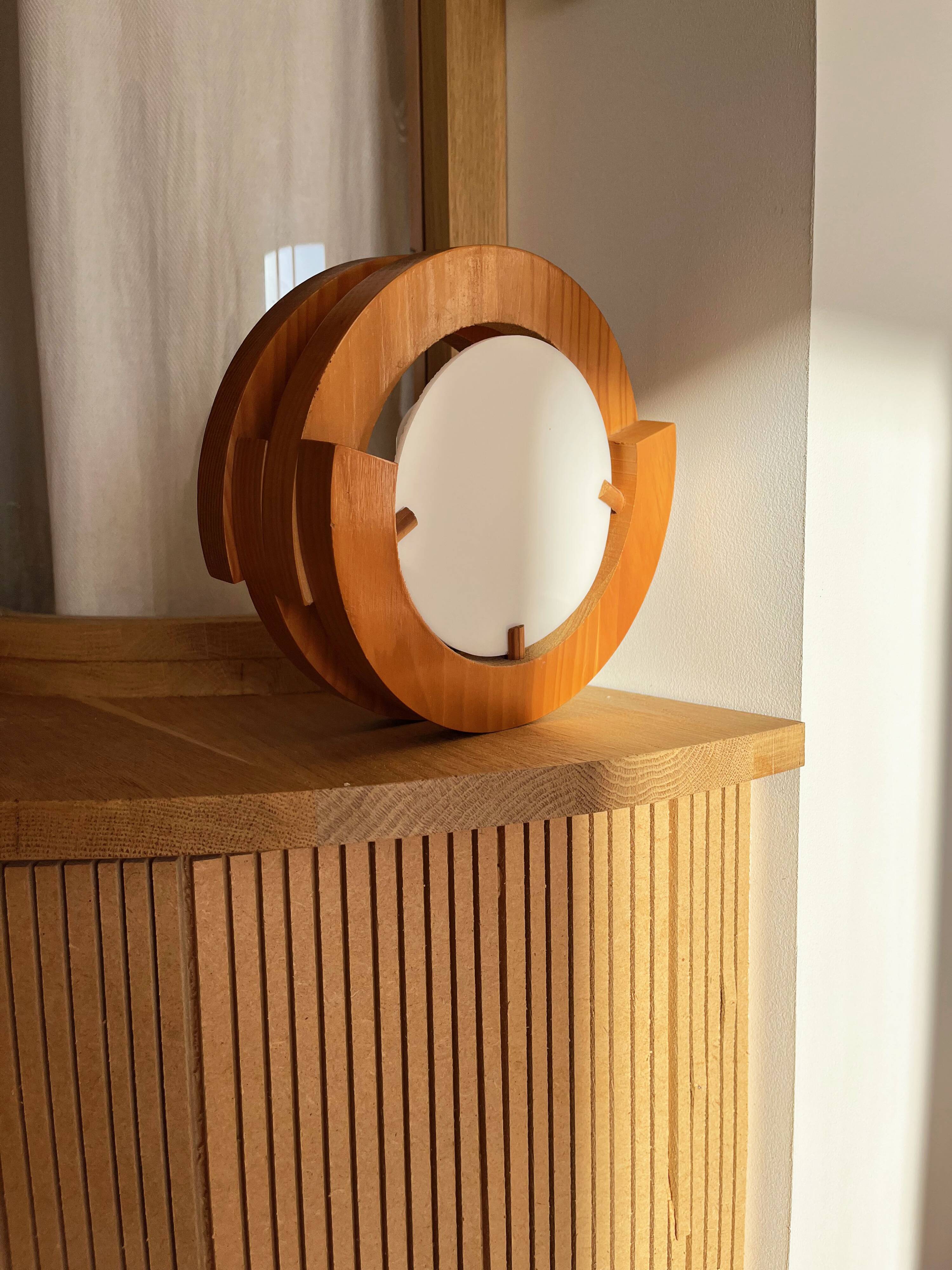Round pine and plexiglass wall light, 1970s