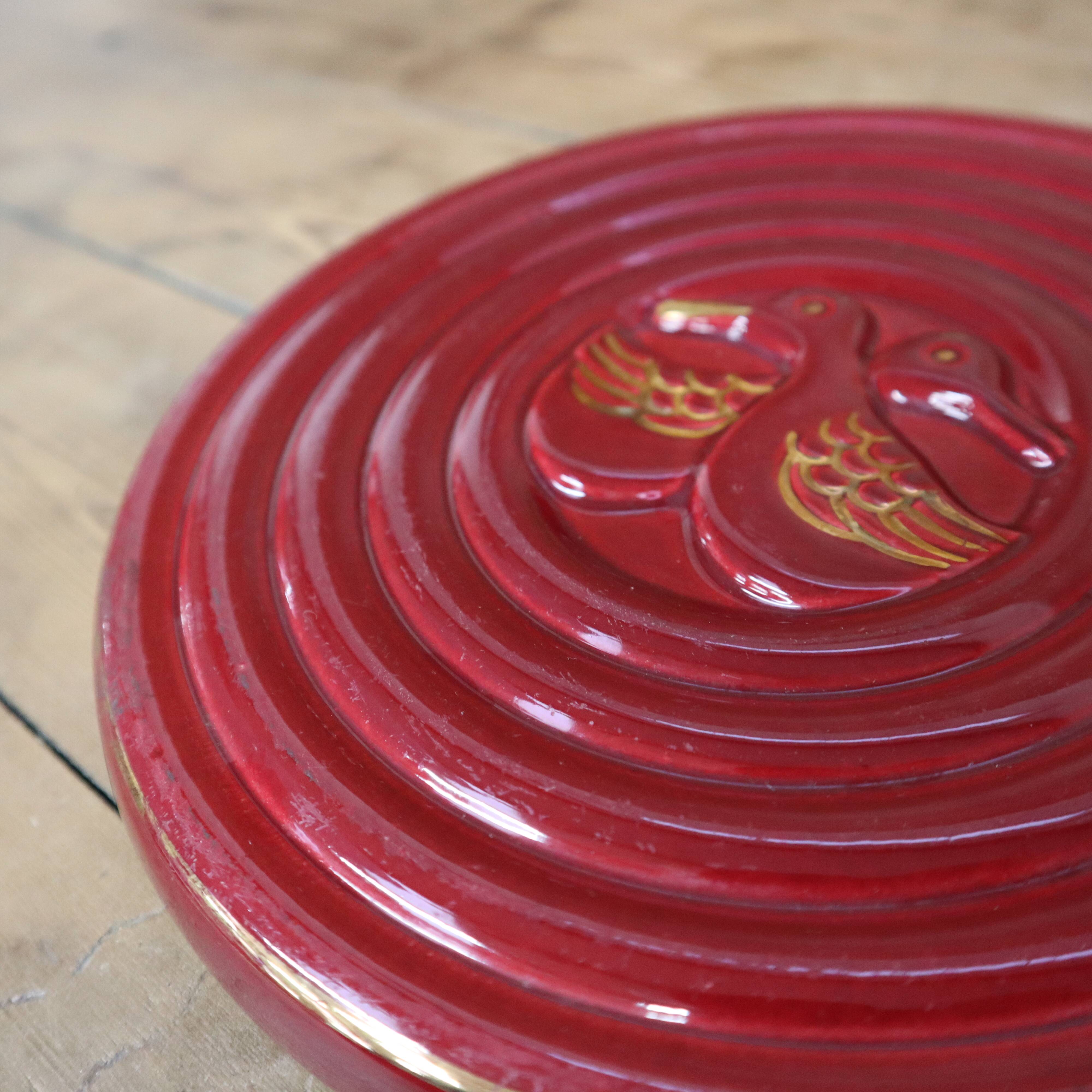 Vintage burgundy duck trivet with gold edging