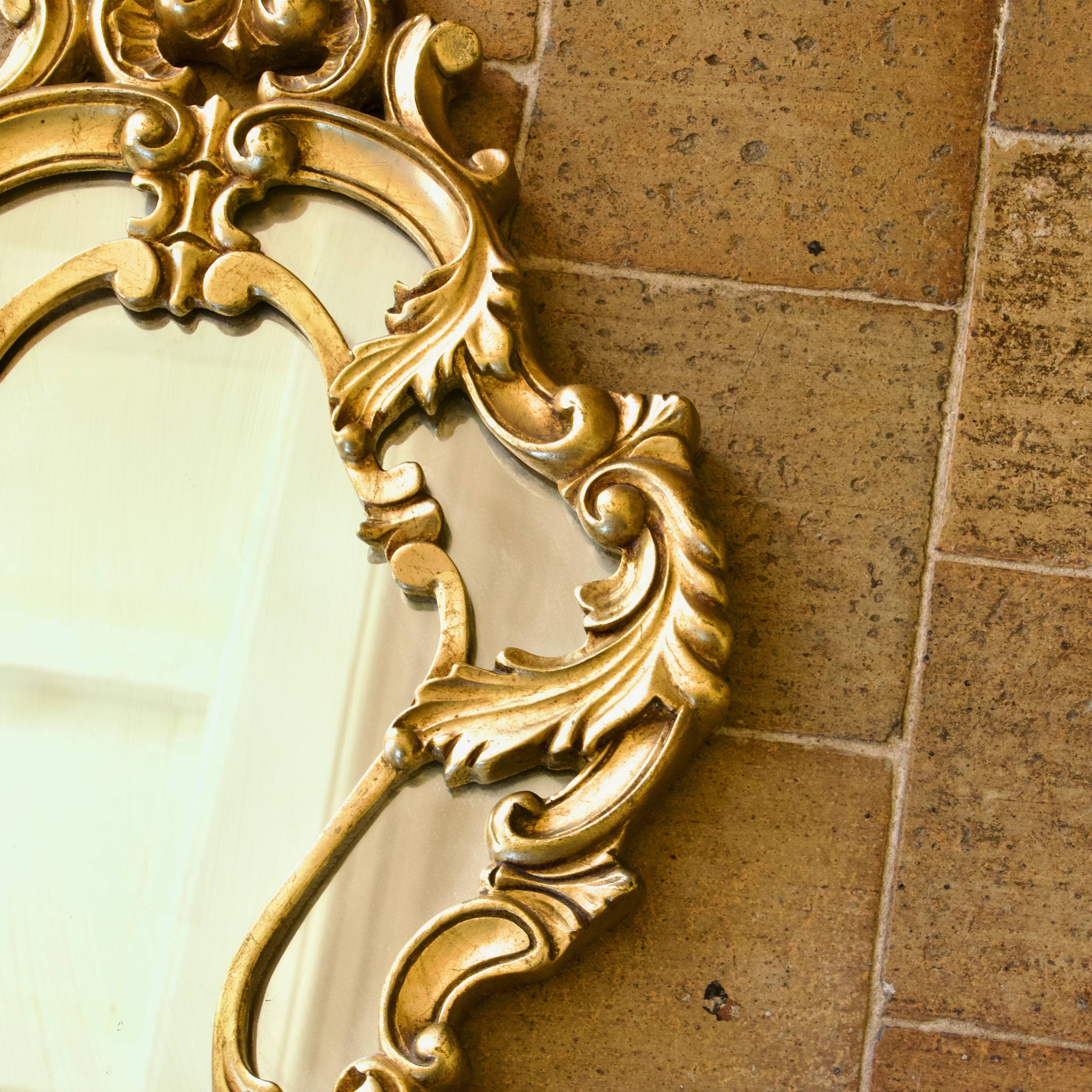Antique Baroque mirror with gilded metal panels