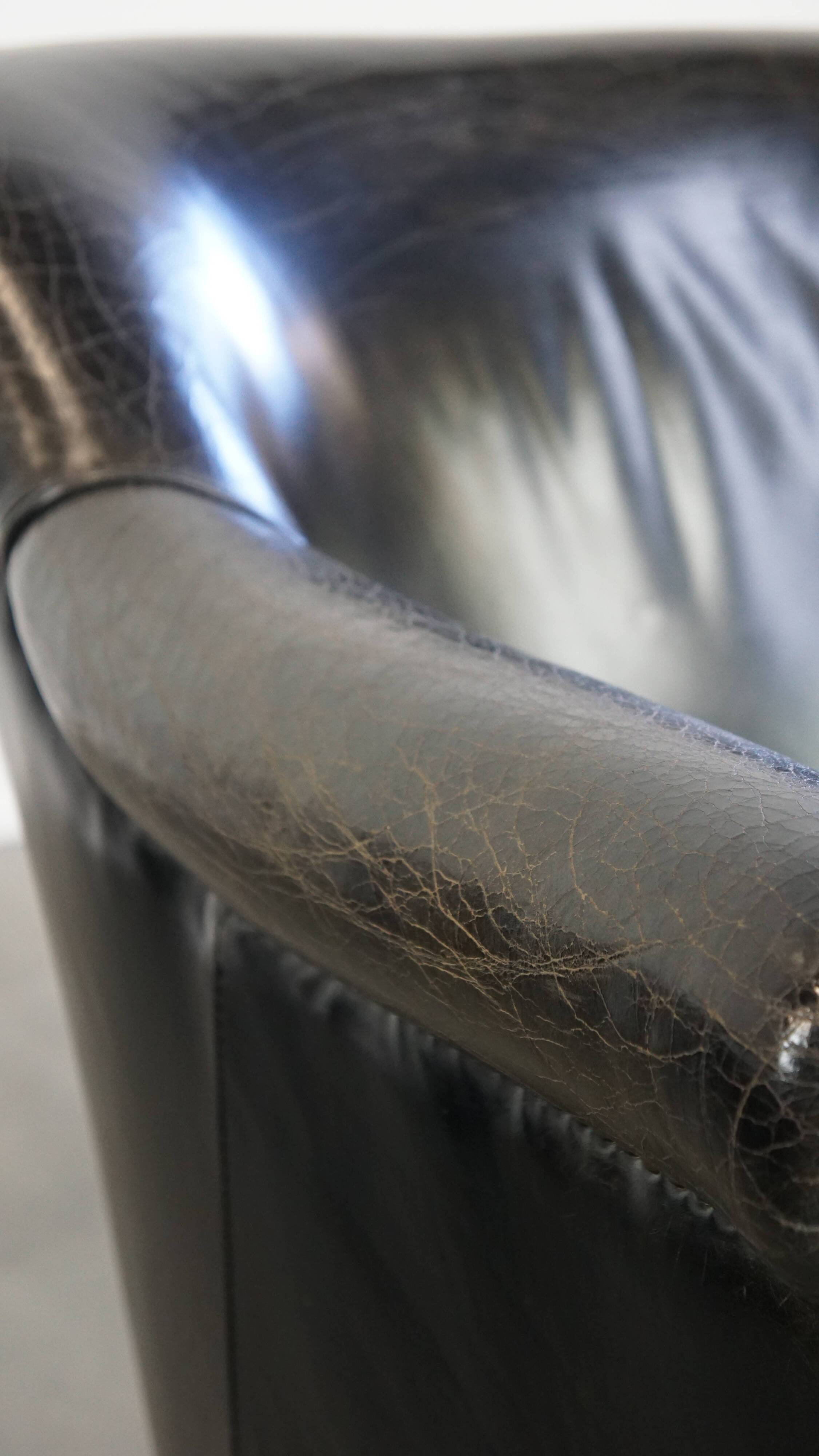 Black grained cowhide leather armchair