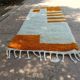Handmade orange and white wool rug, traditionally crafted, size 140 x 260 cm