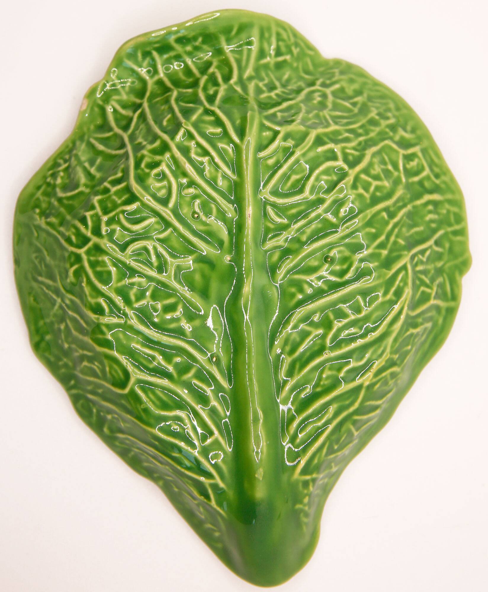 Trompe l'oeil cup bright green cabbage leaf in slip