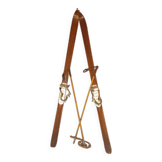 pair of vintage wooden Skis and their bats.
