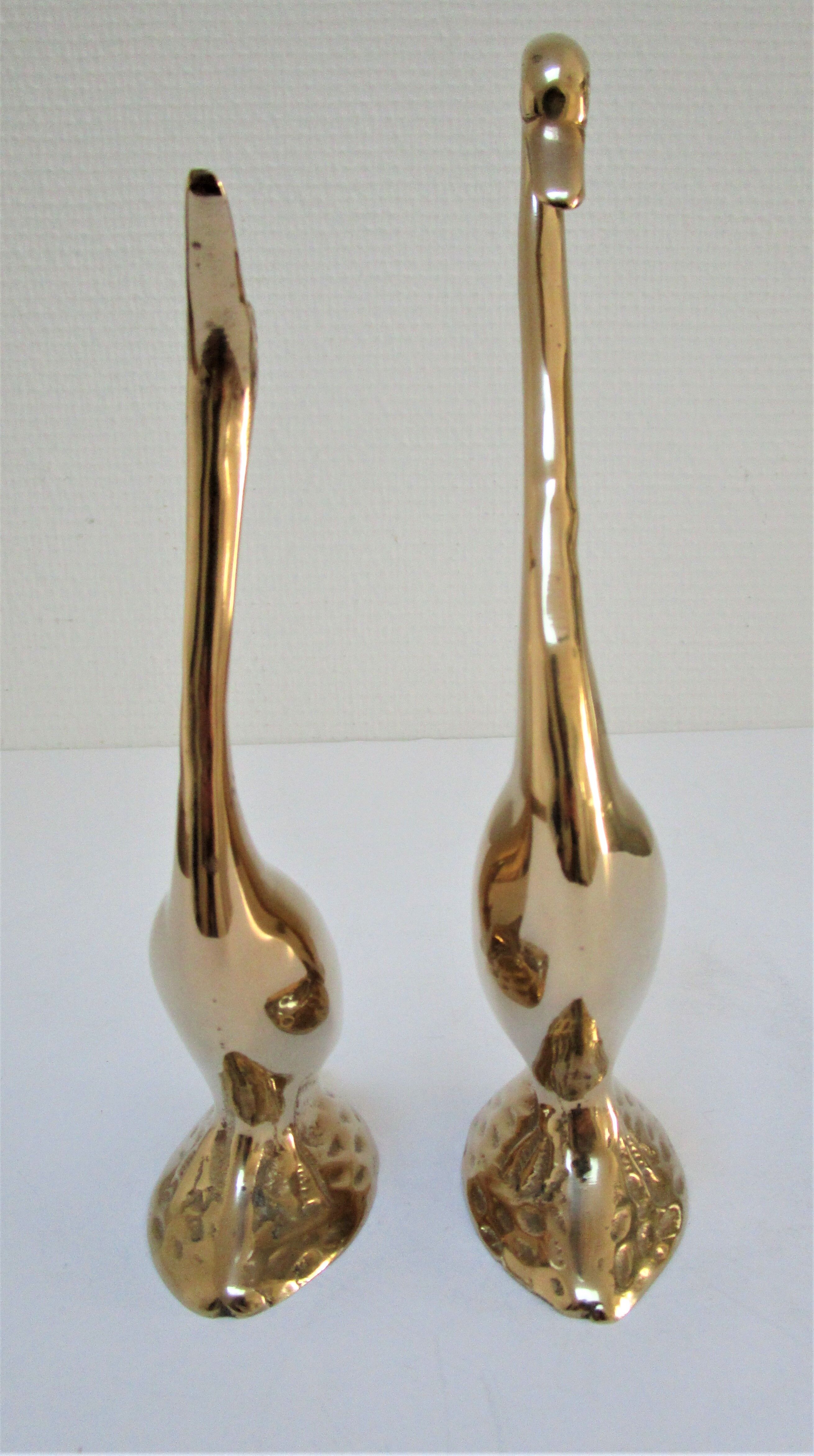 Pair of stylized birds in solid brass