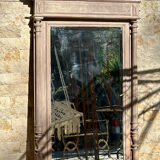 Imposing fireplace mirror in carved and painted wood, 19th century.