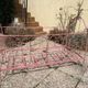 Old iron bed for children, painted pink with scrolls, romantic style.