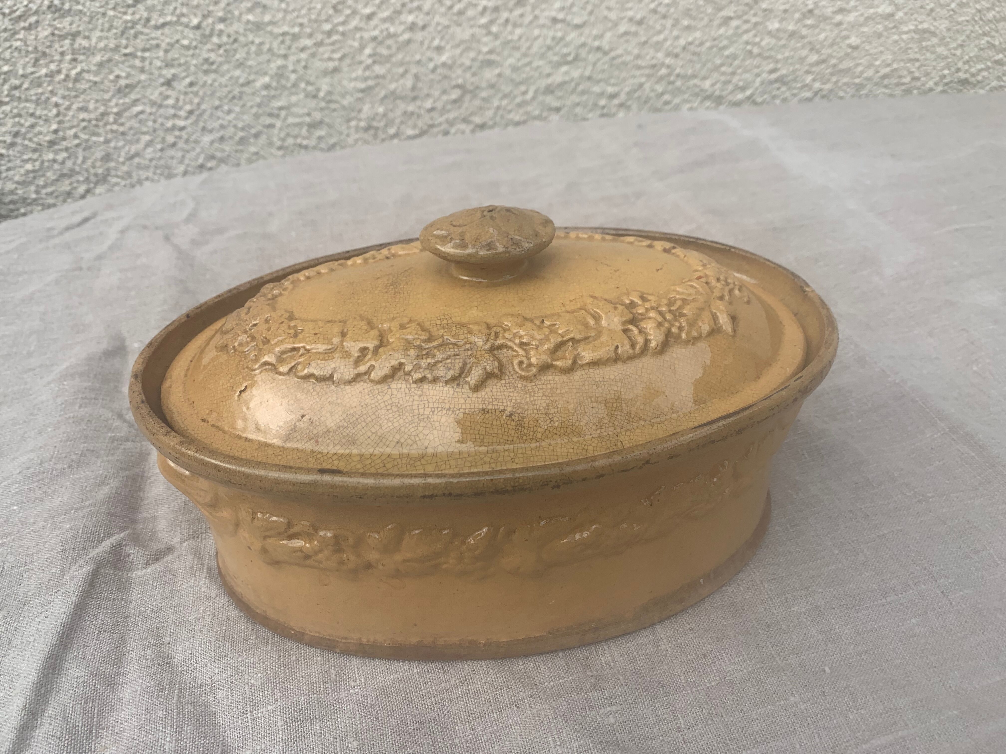 Old terrine in glazed stoneware and floral decoration mustard yellow slip