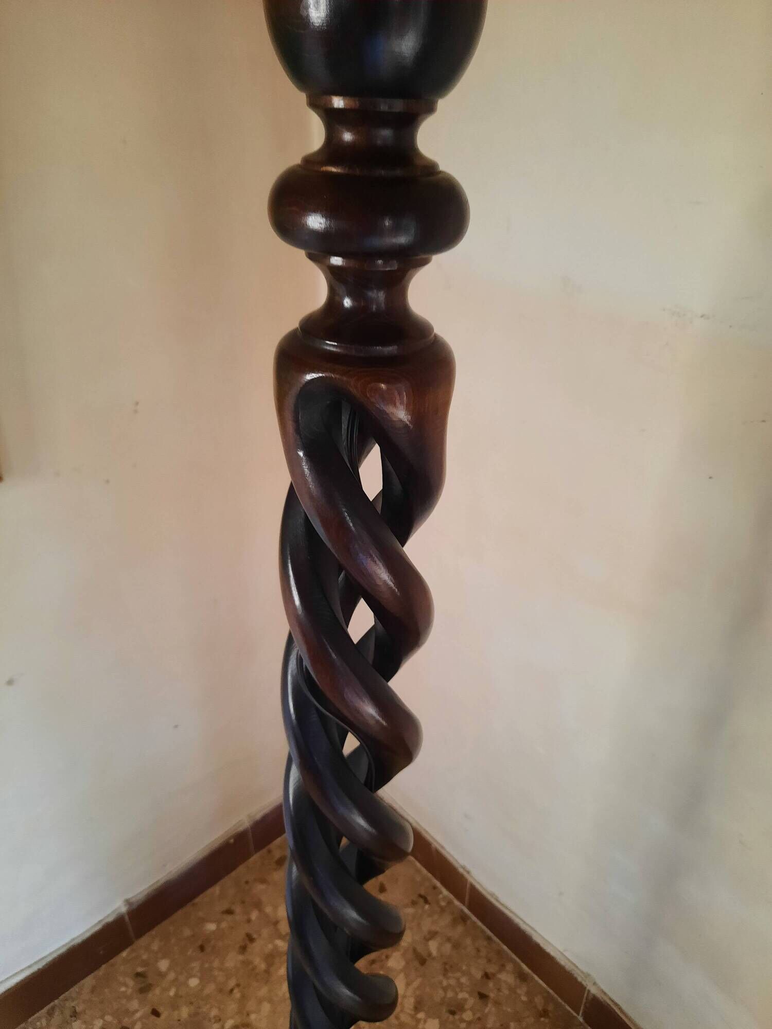 Sculptural floor lamp made of twisted turned wood.
