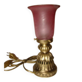 bronze bedside lamp with a pink cracked glass shade