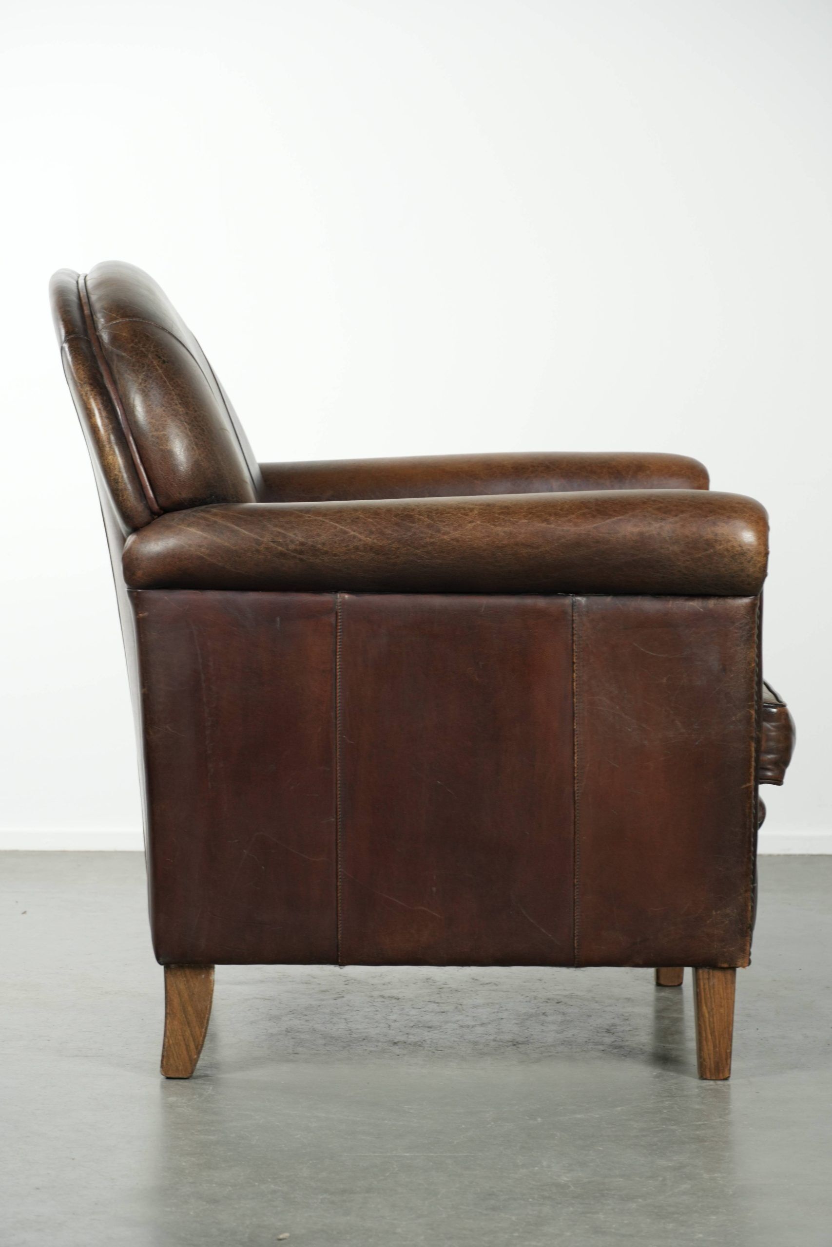 Armchair / lounge chair made of sheepskin leather with characterful patina