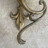 Adjustable wall light in brass and gold metal.