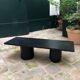 Rectangular coffee table in stained black wood with ball and cylindrical legs.
