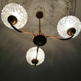antique chandelier has 3 globes