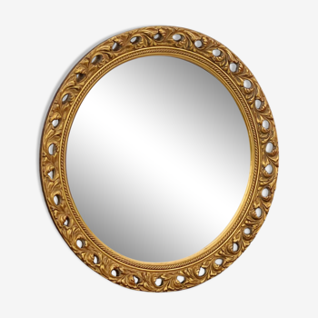 Round neoclassical style mirror in wood and gilded stucco from the 1950s