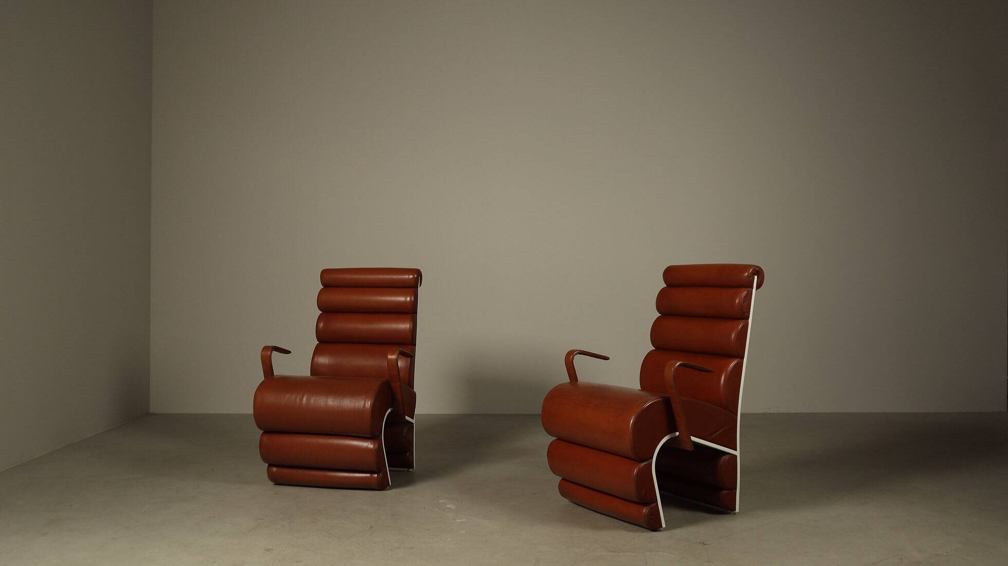 Pair of sculptural cognac leather armchairs, 1970s
