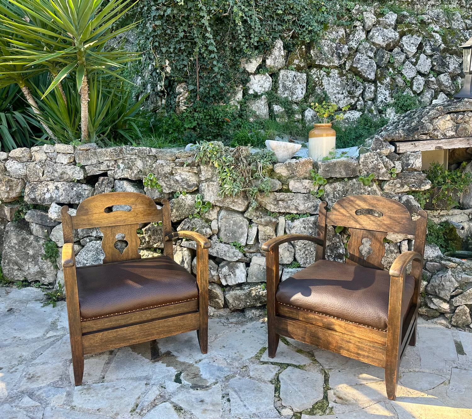 Pair of armchairs in stained wood and leather, 20th century