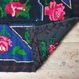 Handwoven floral wool rug, black background with pink roses