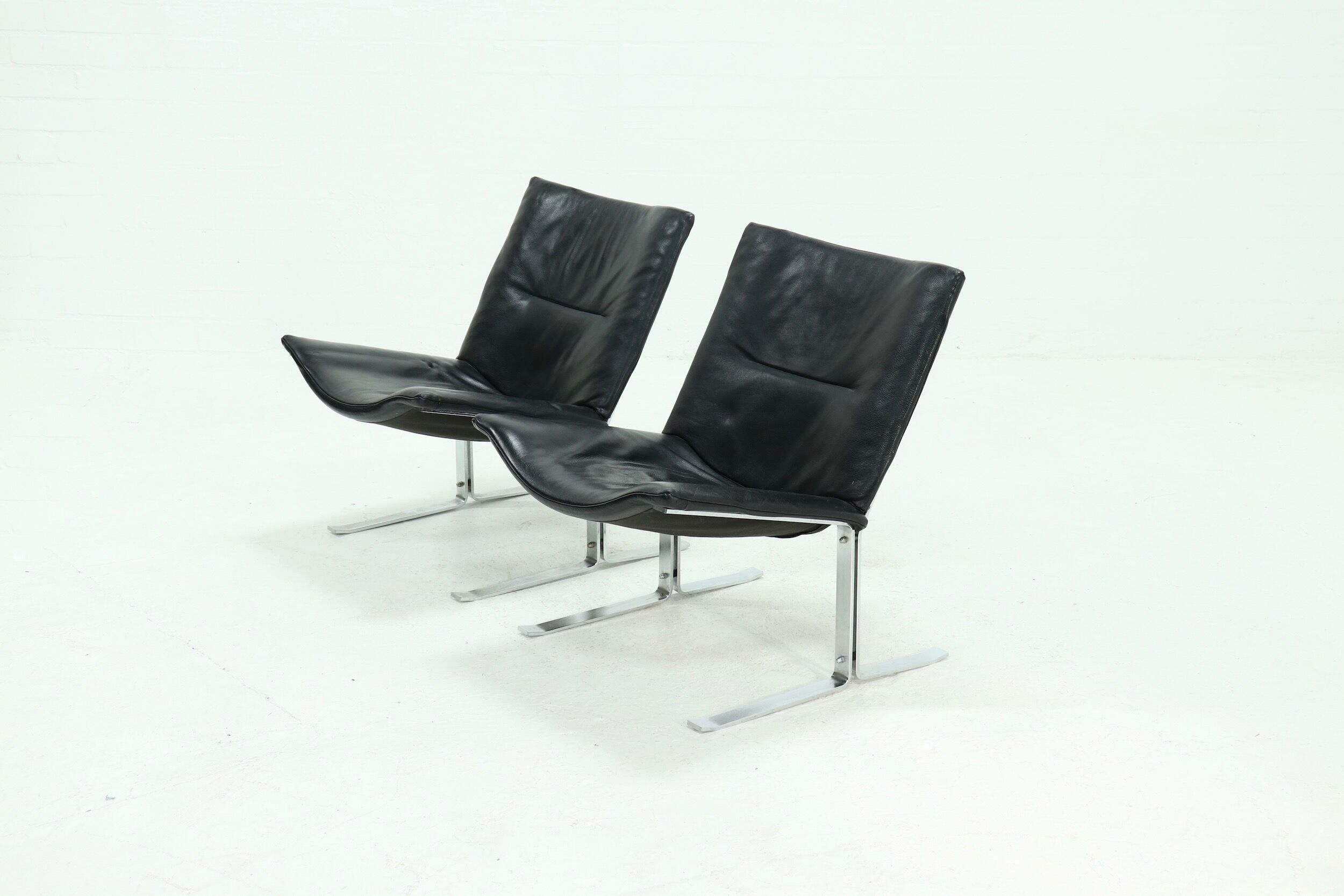 Set of 2 Danish lounge chairs by Kebe Møbler model Eagle with black leather.