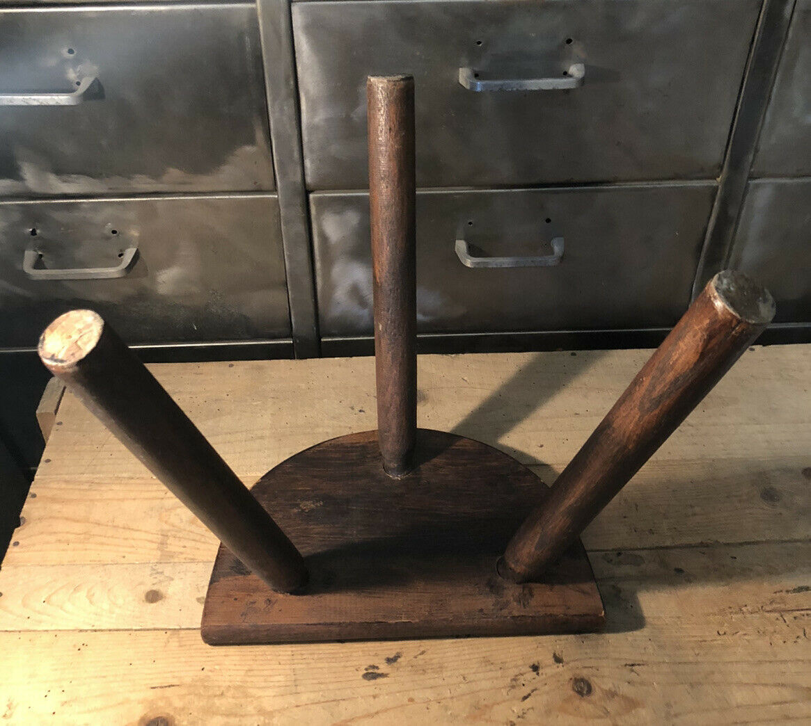 Wooden milking stool on tripod base