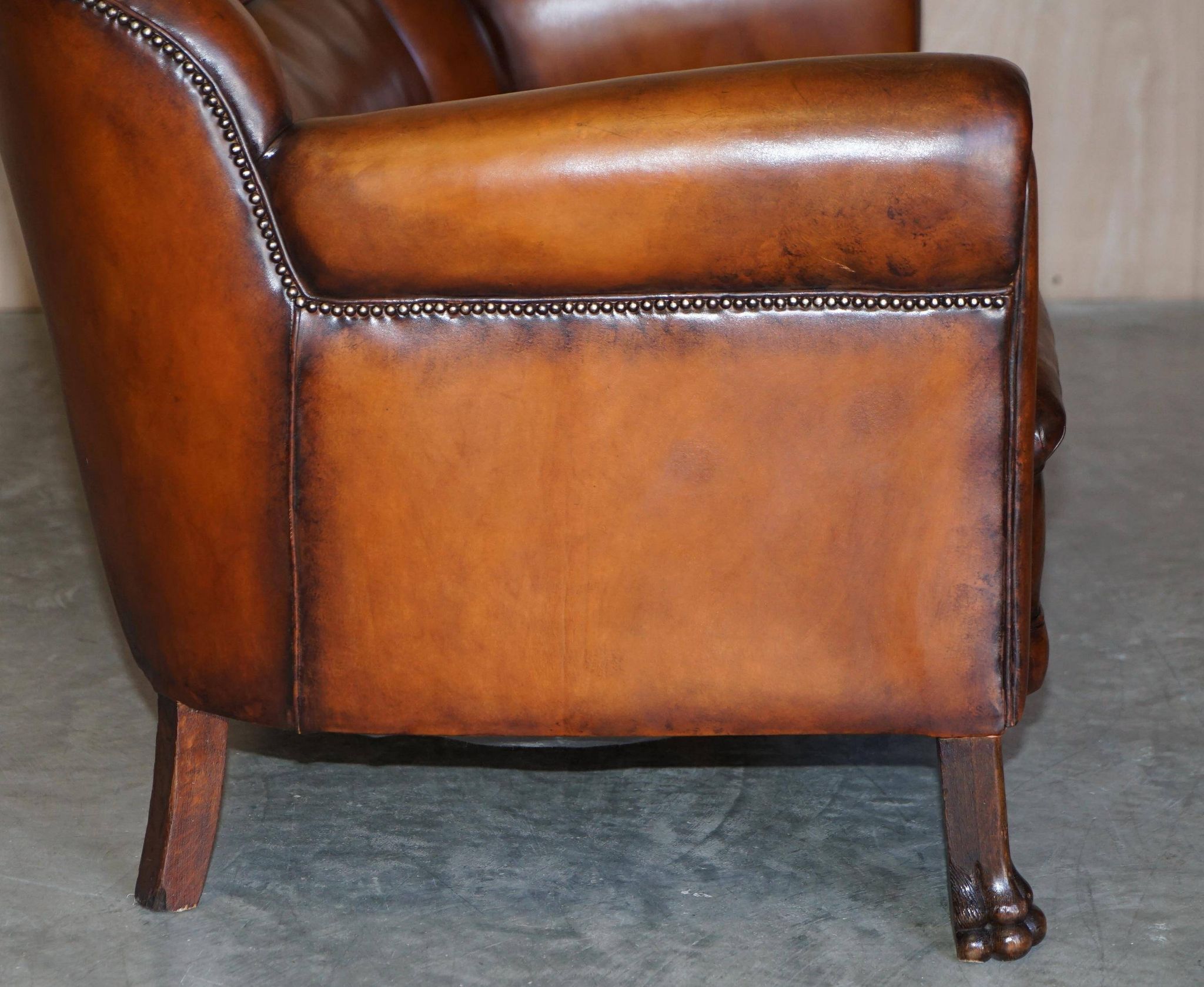 Victorian Chesterfield leather canapé with oak lion claw feet.