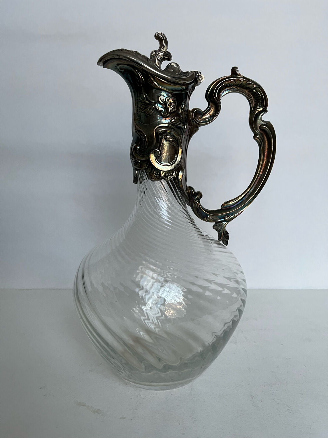 Glass decanter and silver metal frame