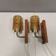A set of wall lamps in teak wood, with amber colored glass