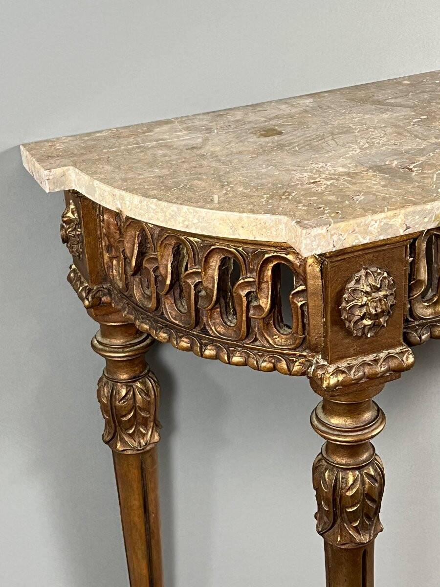 Louis XVI style console in carved wood with a gilded patina, 19th century.