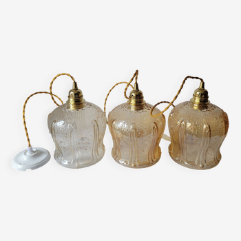 Trio of amber glass pendant lights