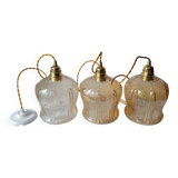 Trio of amber glass pendant lights