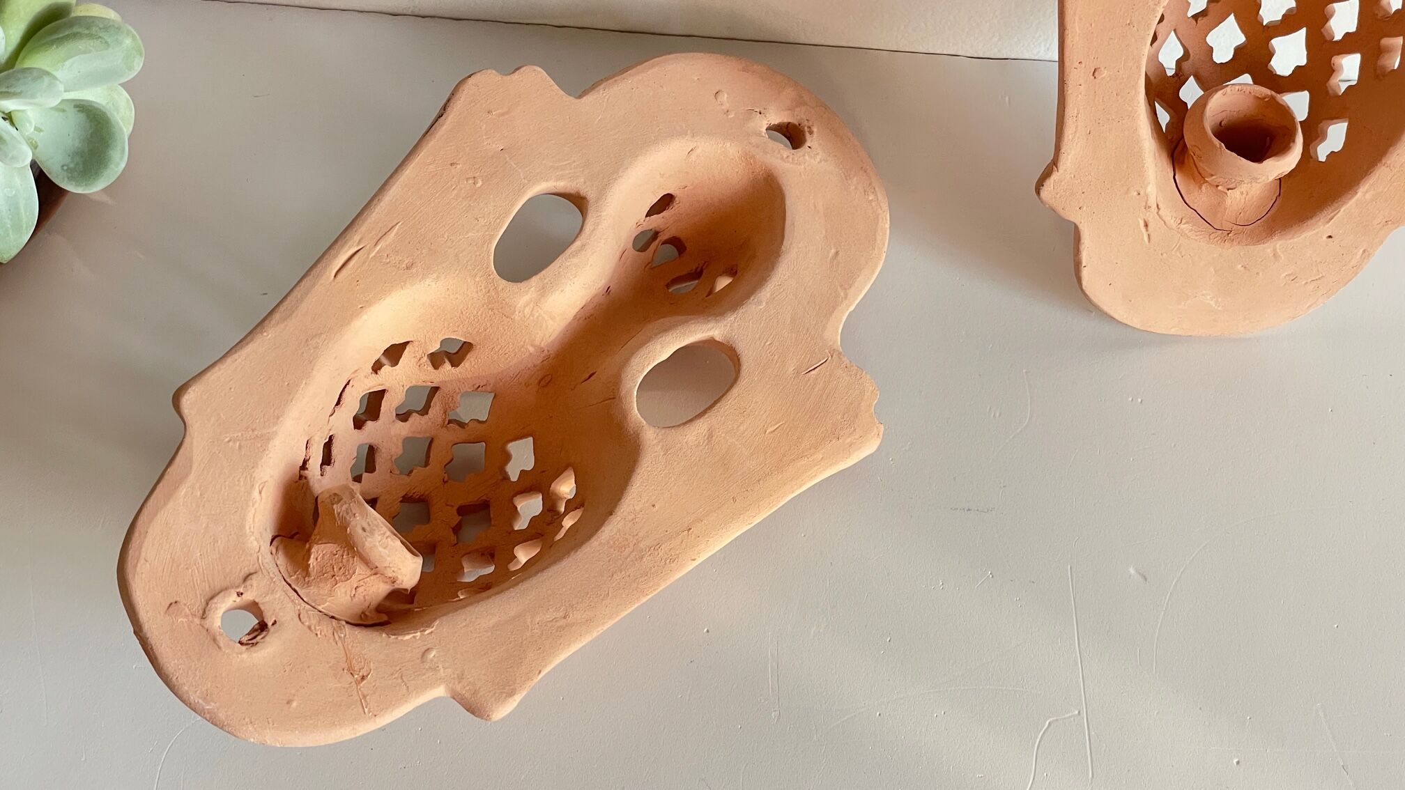 Pair of terracotta wall candle holders