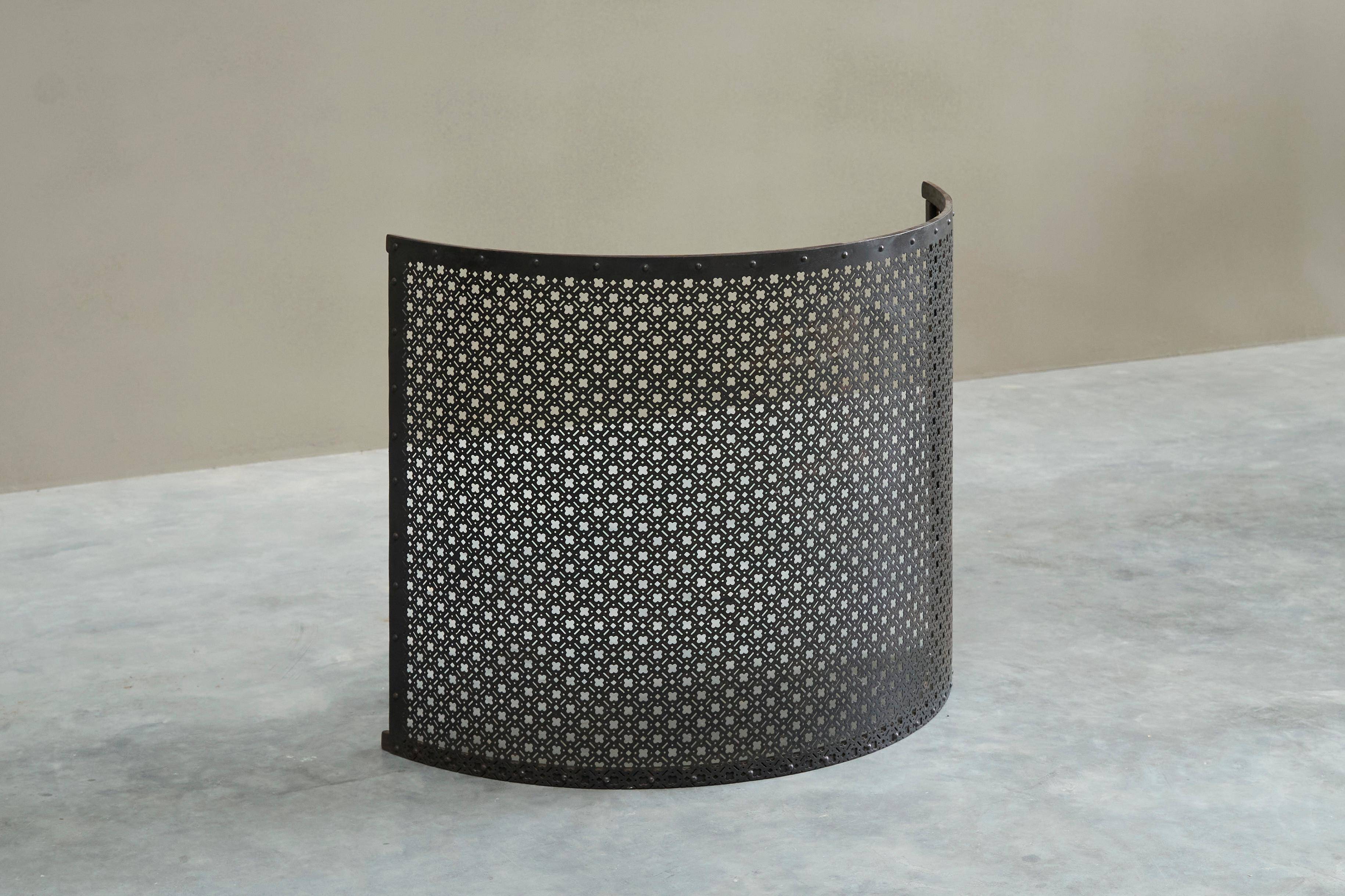 Half-moon antique wrought iron fire screen from the 19th century.