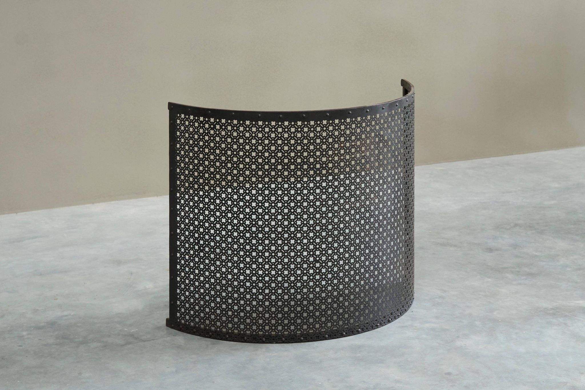 Half-moon antique wrought iron fire screen from the 19th century.
