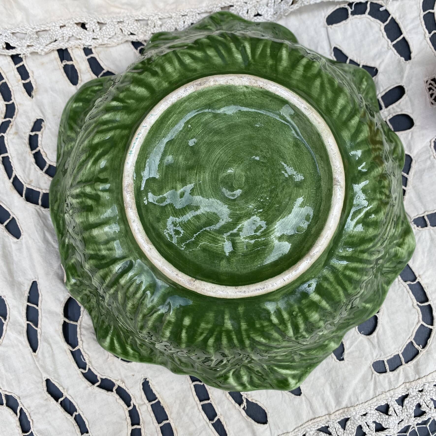 Large earthenware salad bowl in the shape of a cabbage leaf.