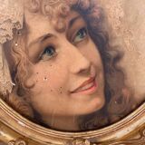 Old oval frame in wood and gilded stucco