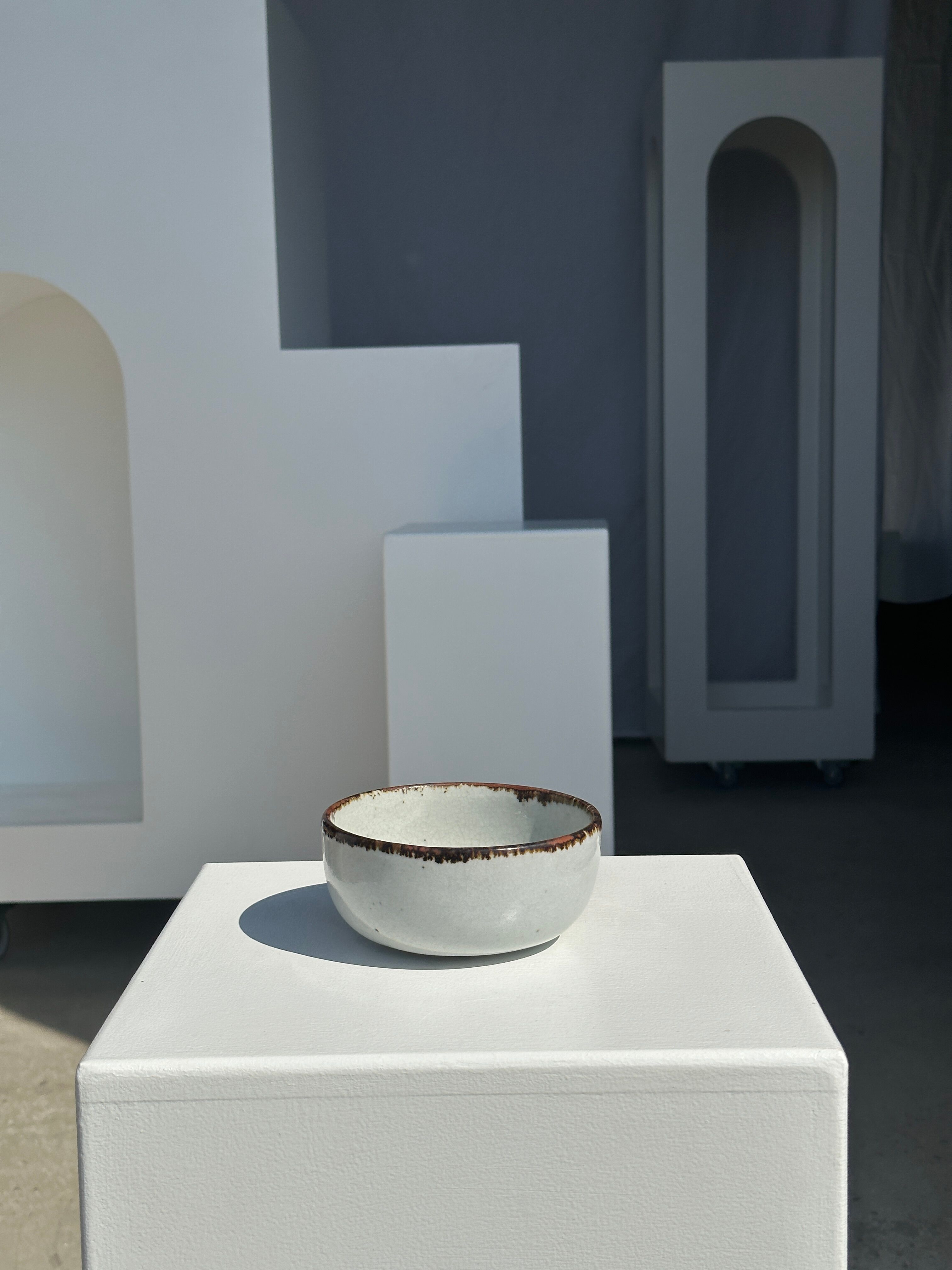 Small white glazed ceramic bowl black edges