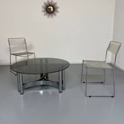 Round coffee table in smoked glass and chrome steel, 1970s design.
