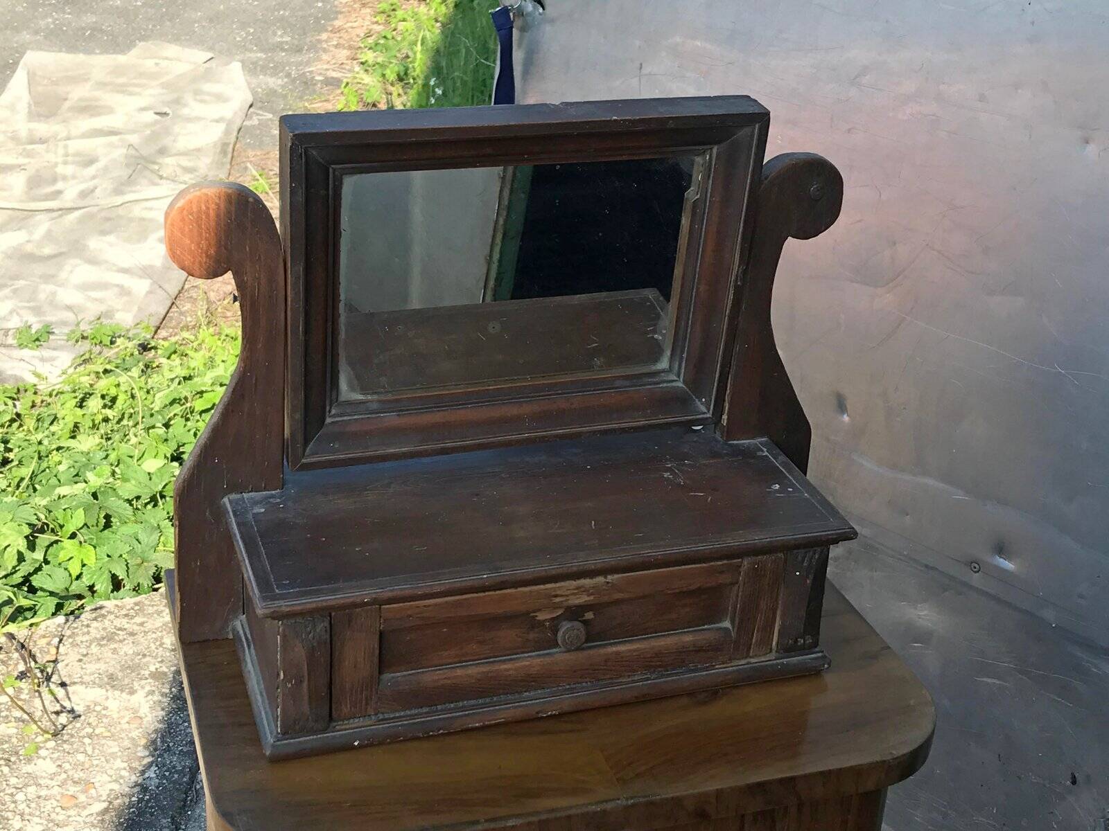 Rustic brown pine mirror, 1920s German style with decorative drawer casing.