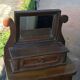 Rustic brown pine mirror, 1920s German style with decorative drawer casing.