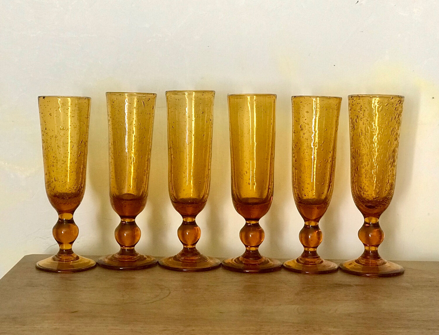 Champagne flutes bubbled amber blown