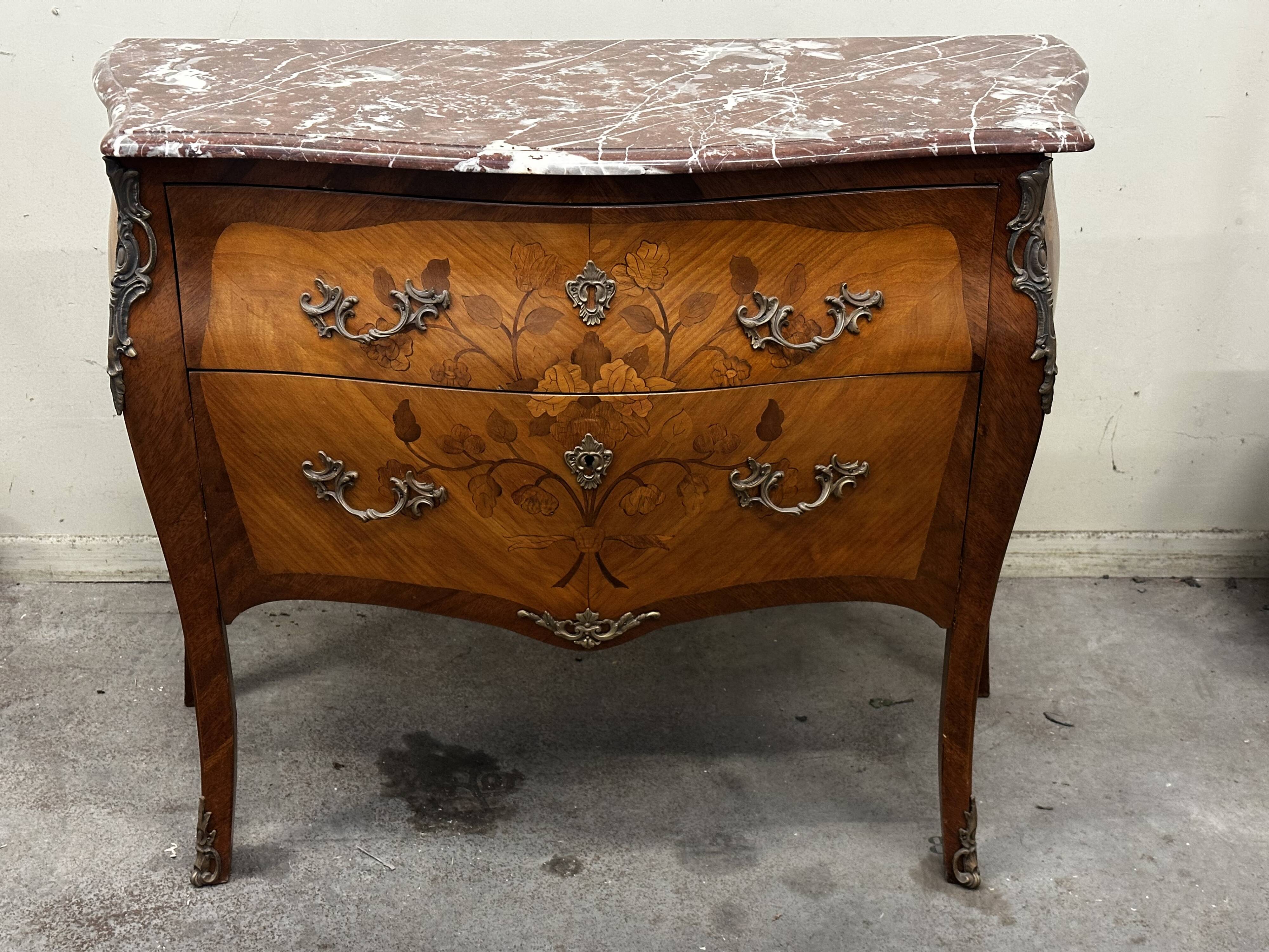 Curved and inlaid Louis XV style chest of drawers