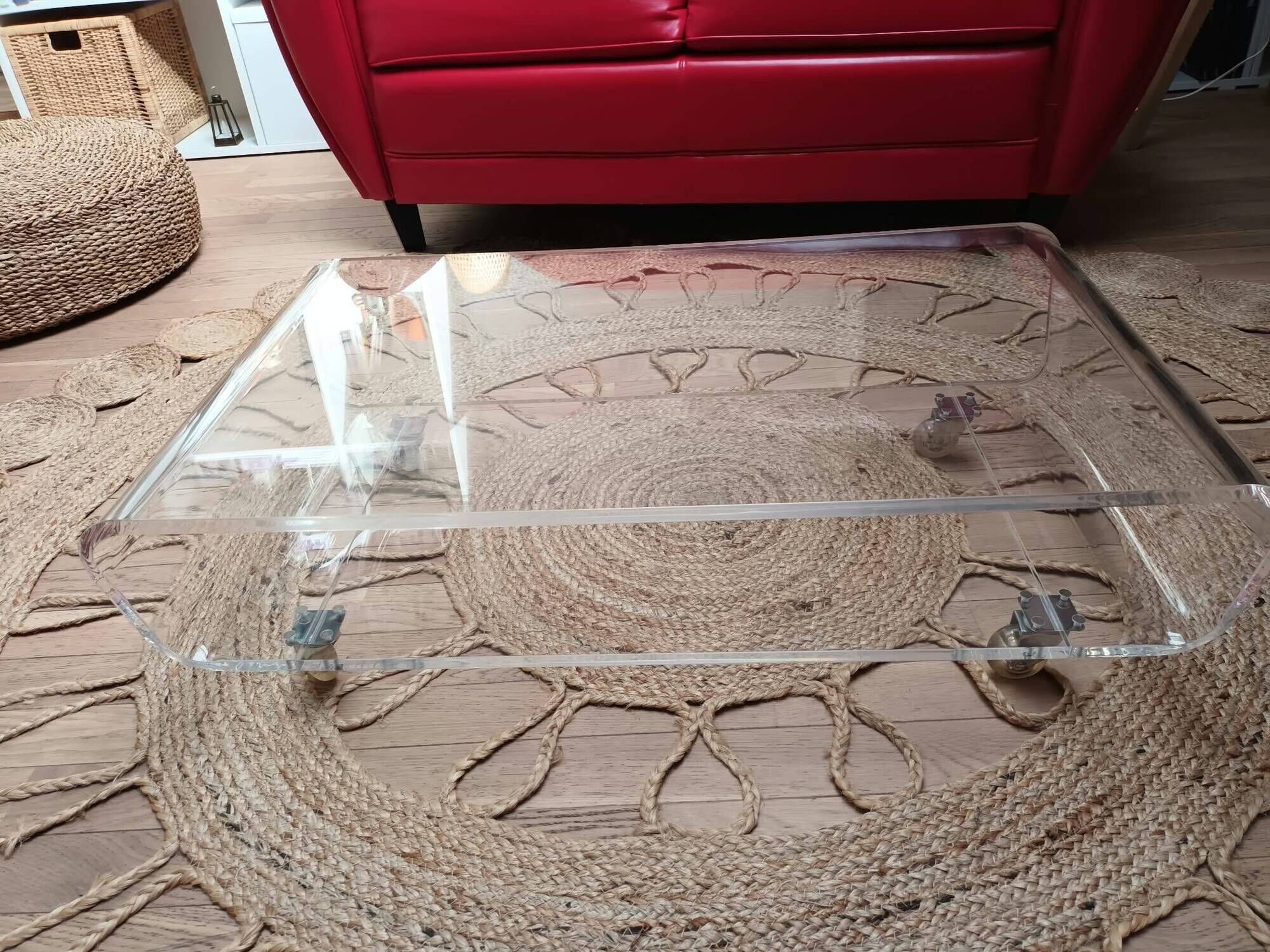 Design coffee table from Habitat in transparent plexiglass, mounted on wheels.