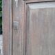 Oak entrance door and its frame and transom, wrought iron gates
