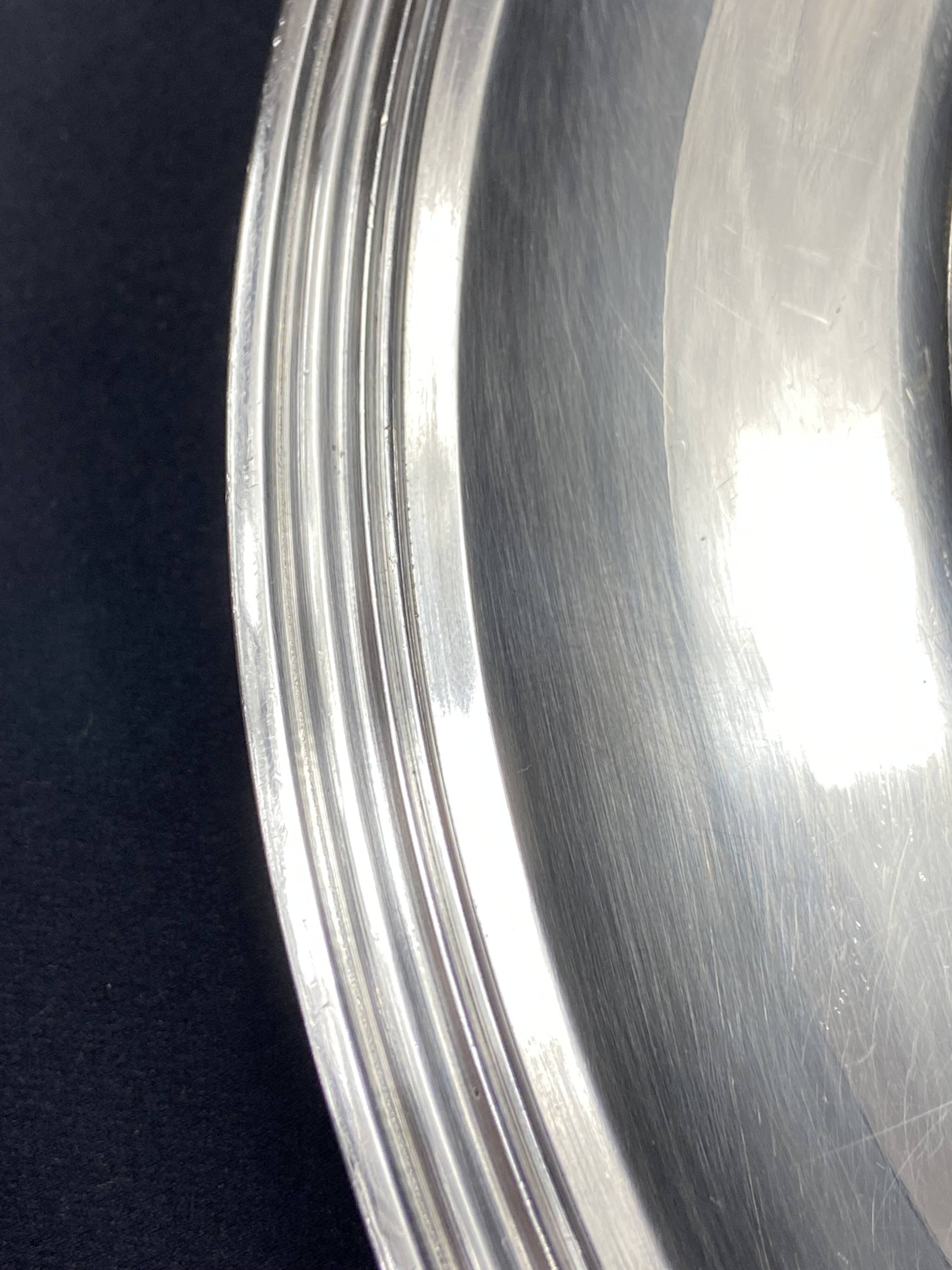 Circular silver-plated metal dish signed ercuis