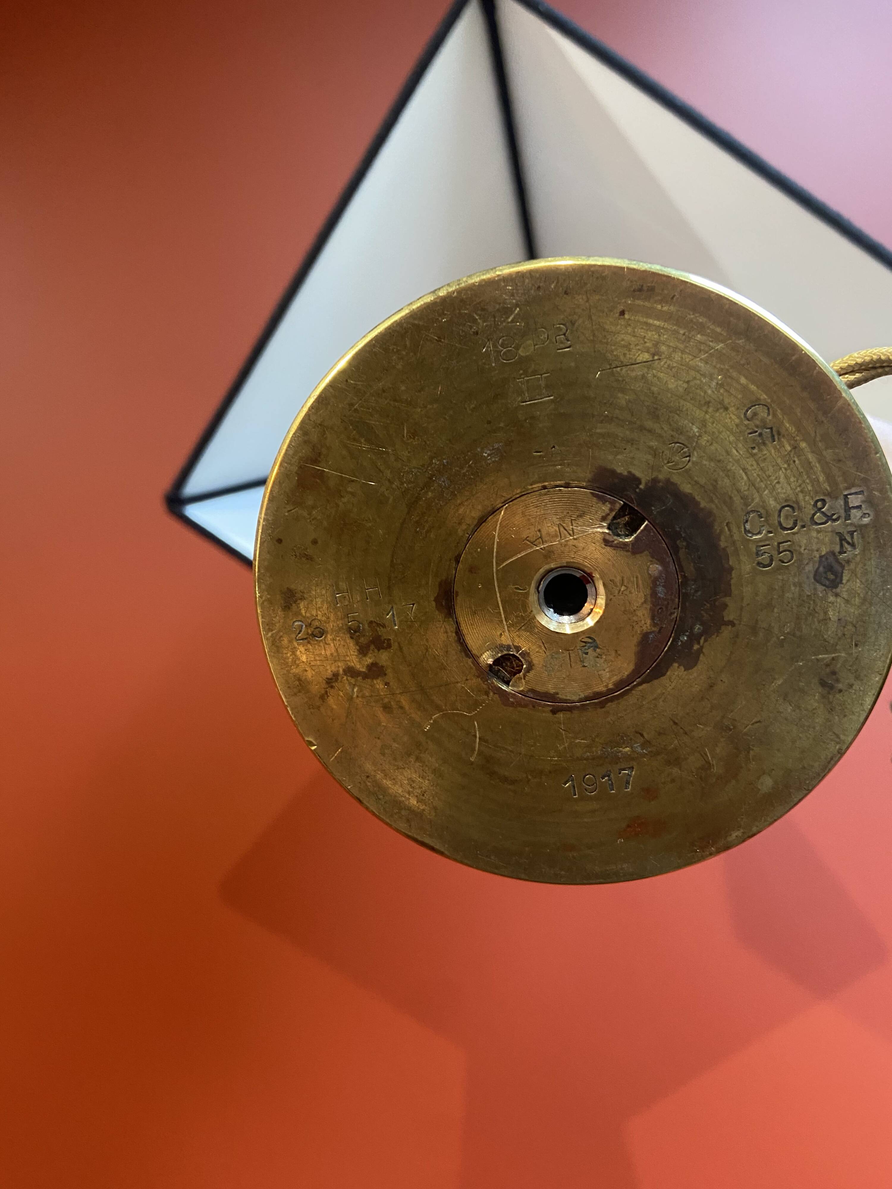 Brass shell socket lamp from the 1st WW, black pyramidal lampshade in Carlucci linen.