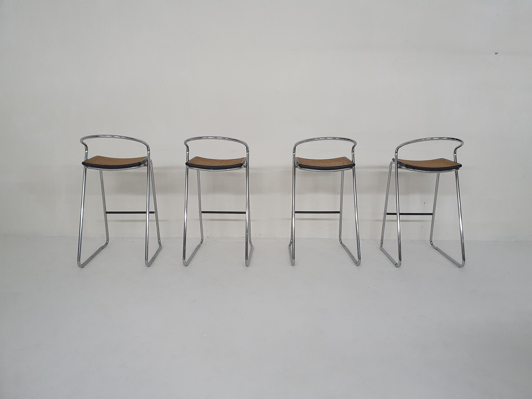 Set of four chrome and cane bar stools, 1970's