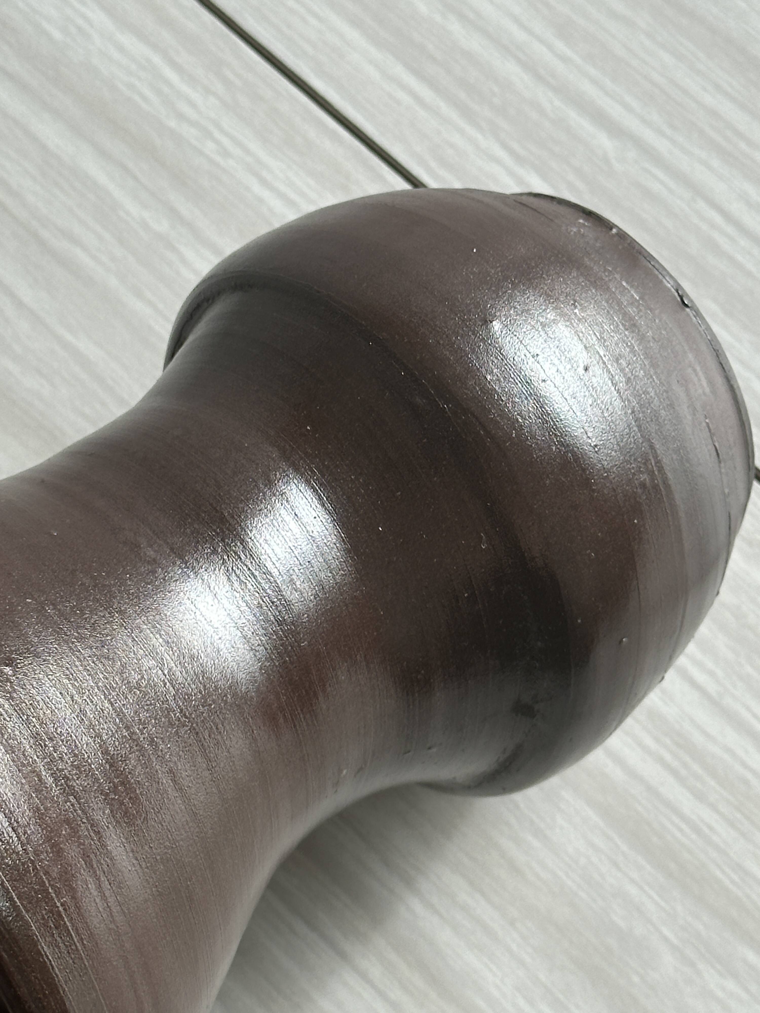 Dark brown ceramic vase, flared shape, smooth finish, classic style