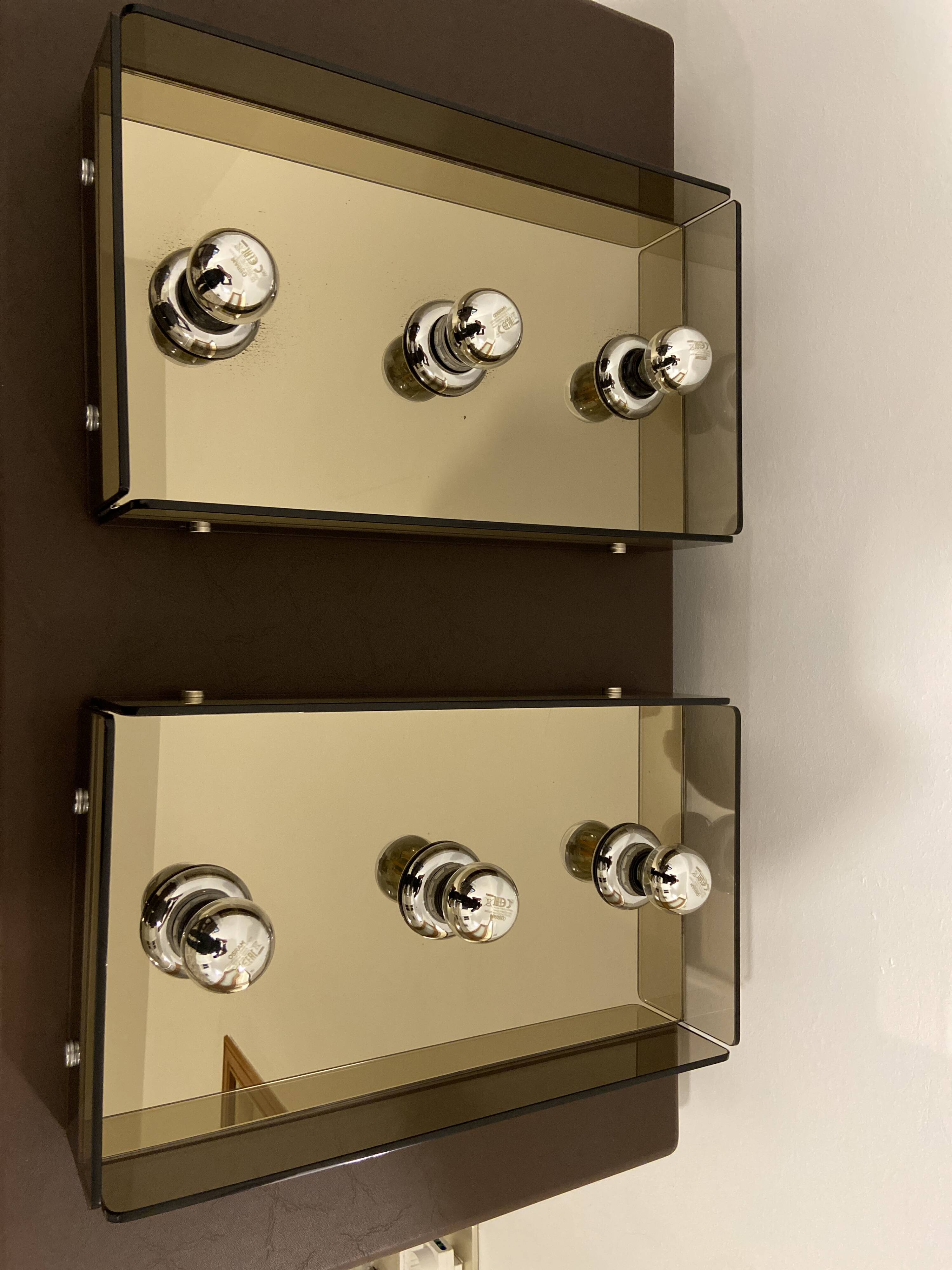 Pair of smoked glass wall lamps, mirrored bottom, Italy 70s